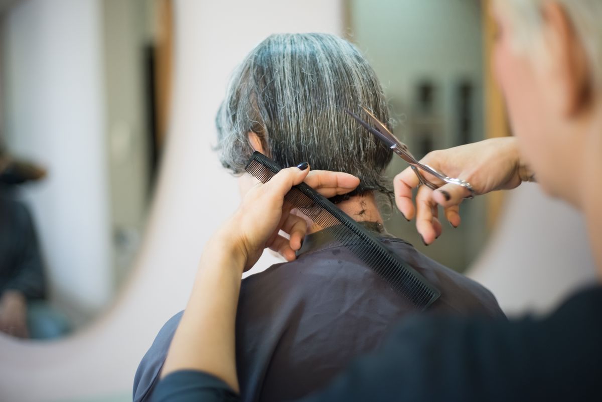 Close-up of a female hairstylist cutting a client's hair